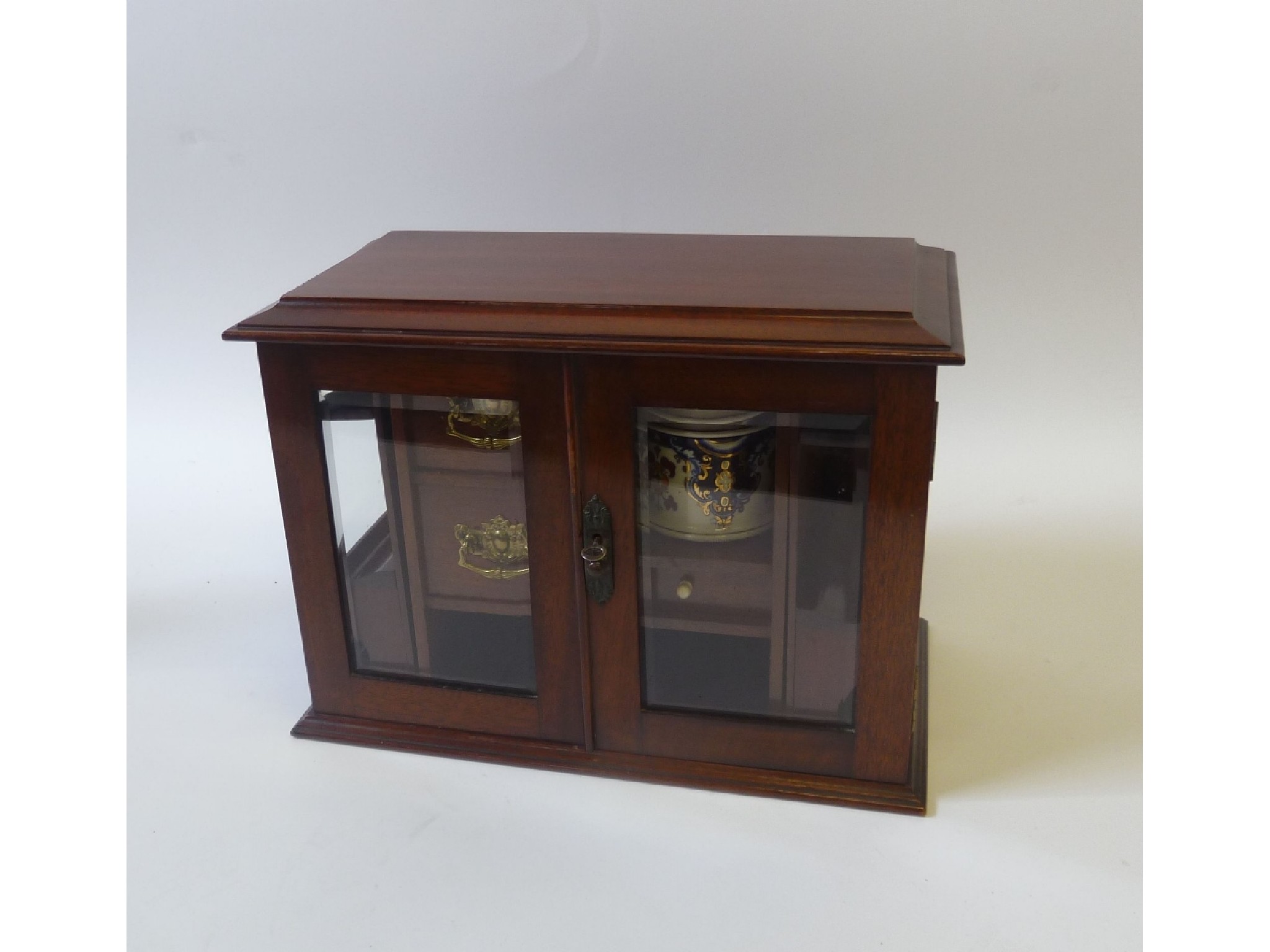 Appraisal: EARLY TWENTIETH CENTURY MAHOGANY SMOKERS CABINET the moulded oblong top