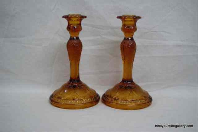 Appraisal: Pair of Tiara Amber Sandwich Glass Candle SticksThe matching pair