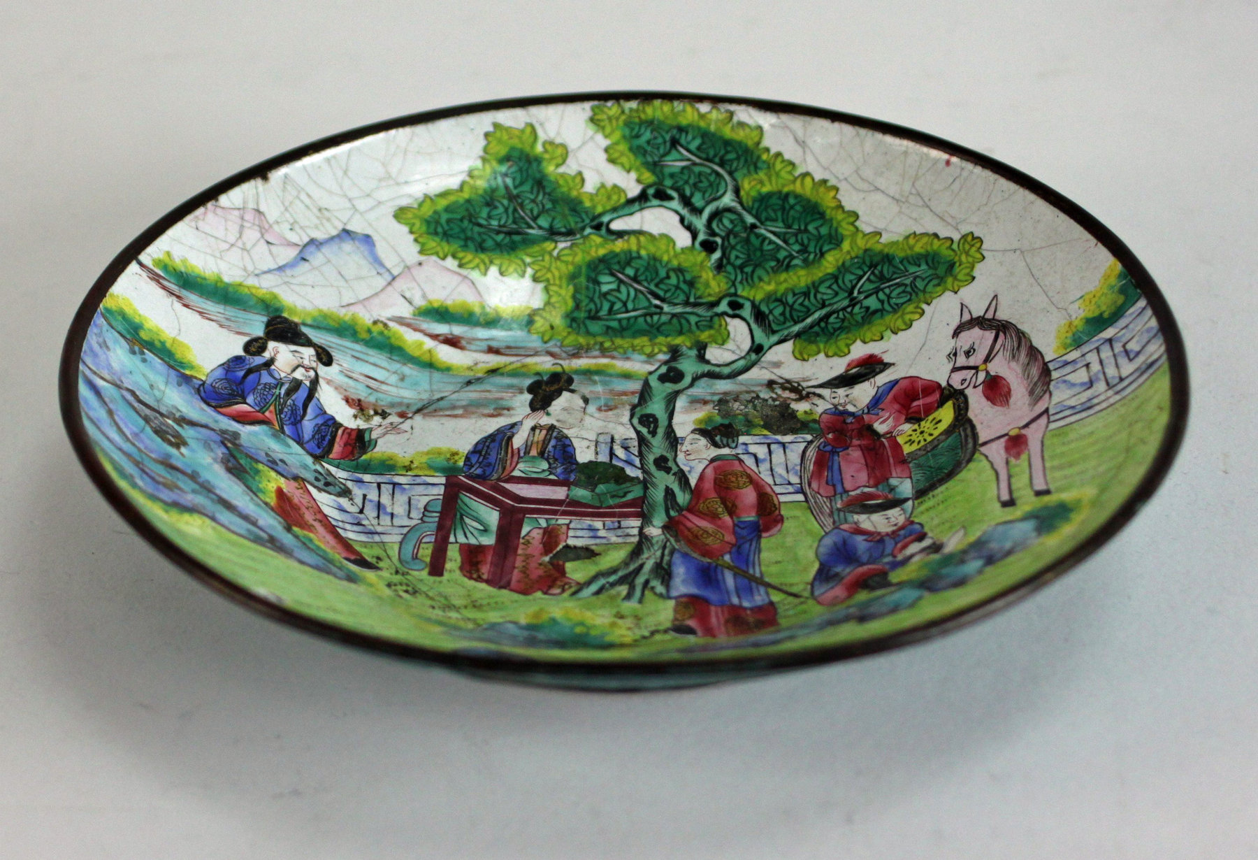 Appraisal: A Chinese enamel saucer decorated figures in a garden cm