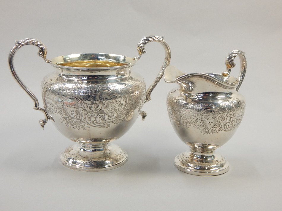 Appraisal: A Victorian silver two handled sugar bowl engraved with scrolls