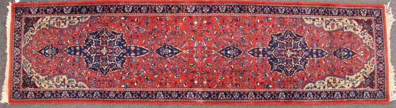 Appraisal: Persian Style Runnerhand knotted red field with two anchored medallions