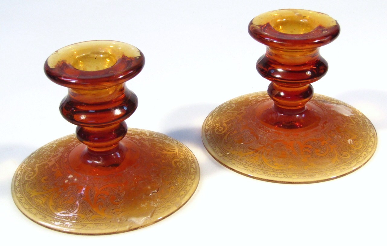 Appraisal: A pair of amber and etched glass squat dwarf candlesticks