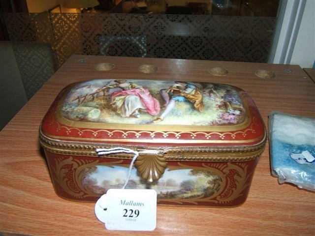 Appraisal: A Continental burgundy ground porcelain box with gilt metal mounts