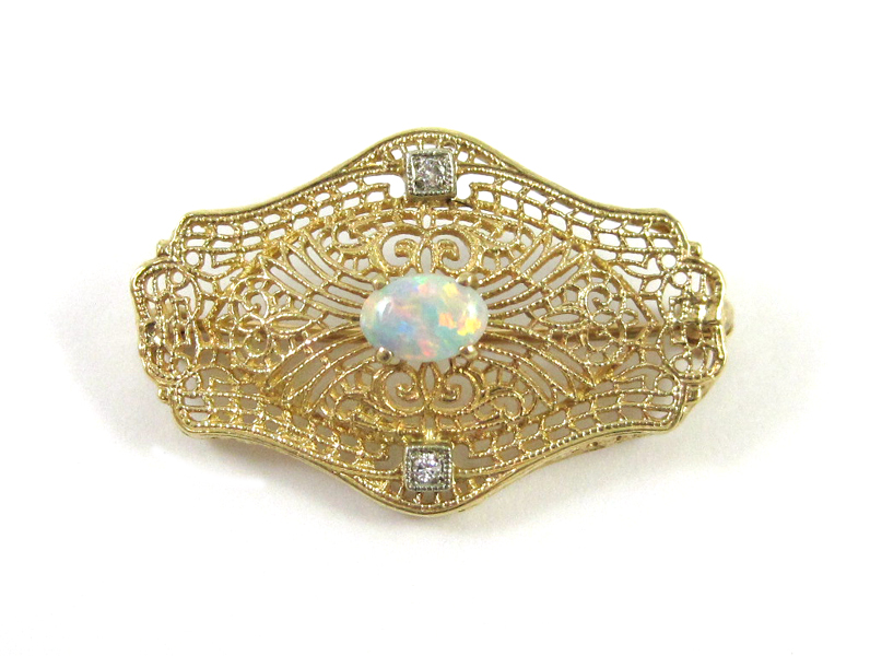 Appraisal: OPAL DIAMOND AND FOURTEEN KARAT GOLD BROOCH The pierced yellow