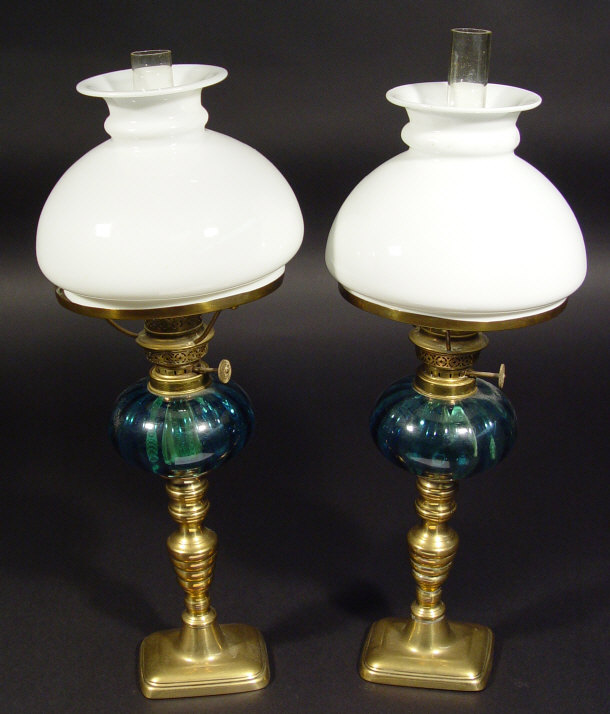 Appraisal: Pair of brass pedestal oil lamps with blue fluted glass