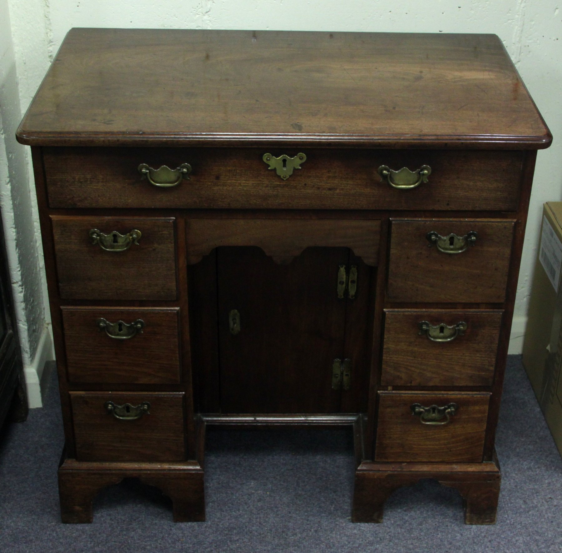 Appraisal: A mid th Century mahogany kneehole desk the top with