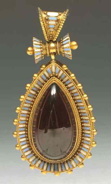 Appraisal: AN EGYPTIAN REVIVAL GARNET AND ENAMELLED PENDANT with beaded decoration