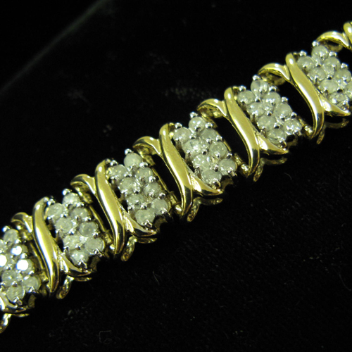 Appraisal: DIAMOND AND FOURTEEN KARAT GOLD BRACELET with X-form gold links