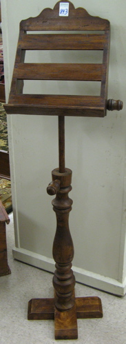 Appraisal: WALNUT LECTERN the canted book rest on a turned support