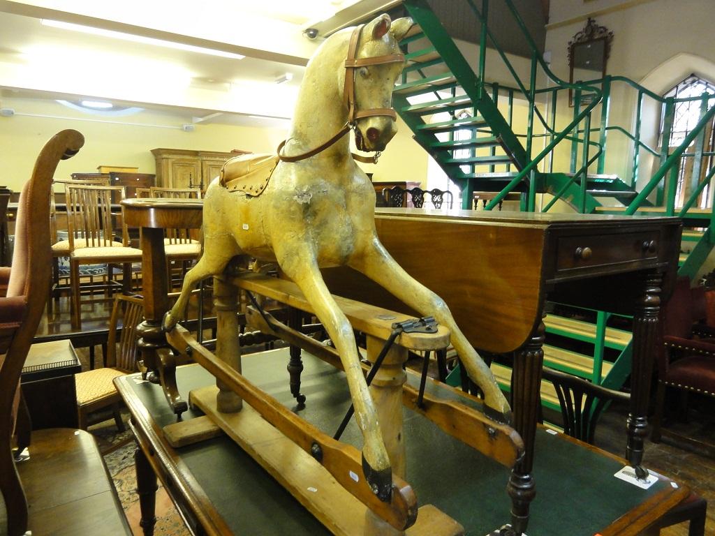 Appraisal: A Victorian rocking horse raised on a stripped pine stand