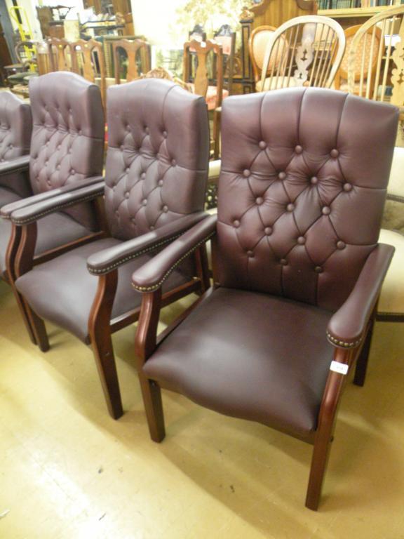 Appraisal: A set of three burgundy upholstered office type chairs