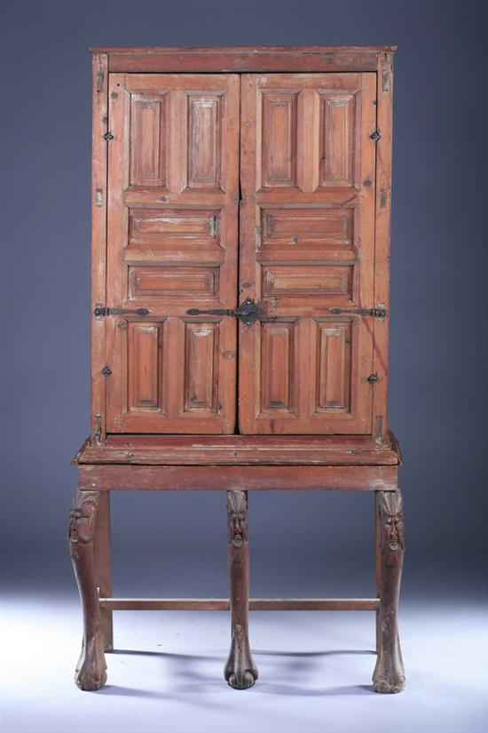 Appraisal: CONTINENTAL FRUITWOOD PANELLED TWO-DOOR CABINET-ON-STAND Early th century possibly Spanish