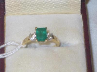 Appraisal: AN EMERALD AND DIAMOND RING the trapp-cut emerald claw set