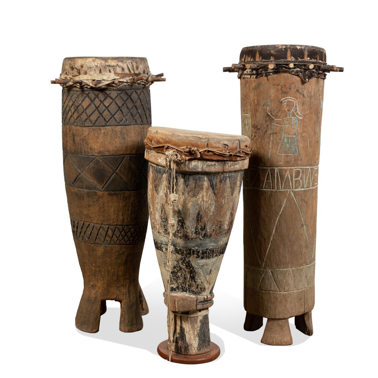 Appraisal: THREE TALL WEST AFRICAN CARVED WOOD DRUMS Three tall West