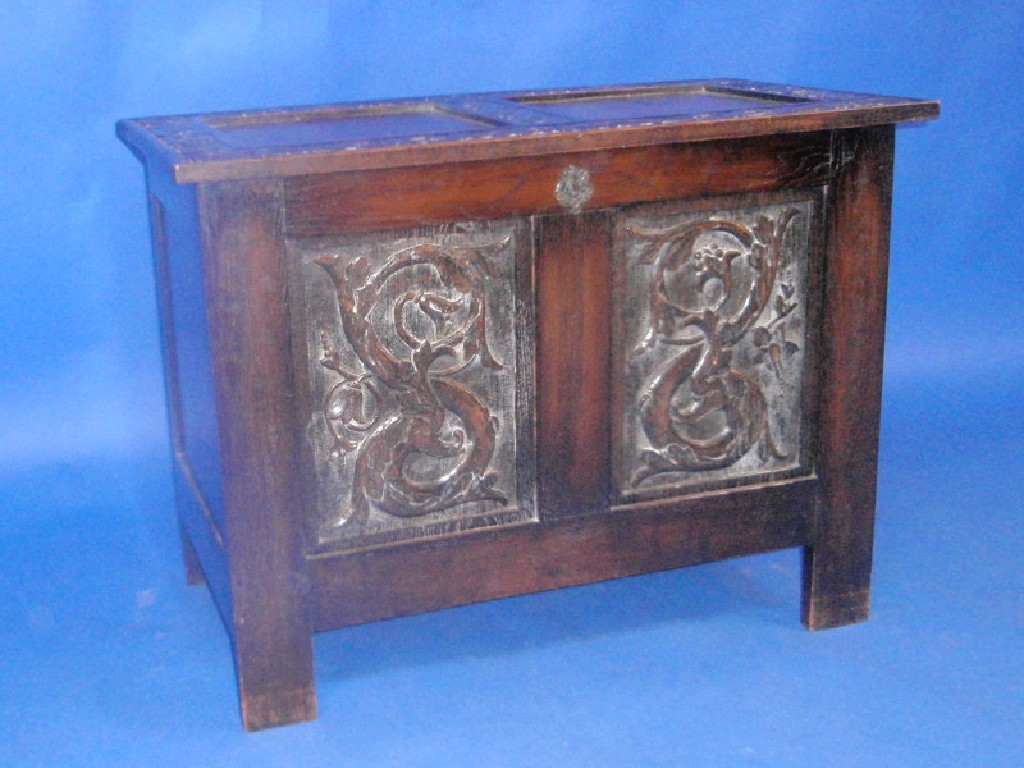 Appraisal: A thC style oak two panel coffer with carved decoration