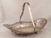 Appraisal: A shaped and pierced silver basket with swing handle on