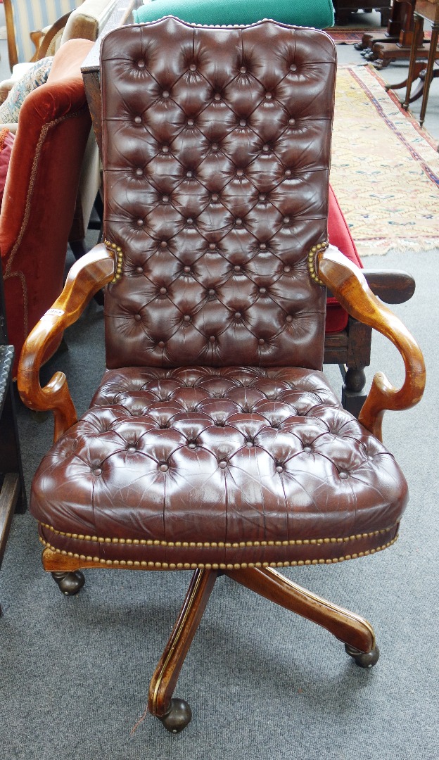 Appraisal: A th century brown leather button back upholstered mahogany framed