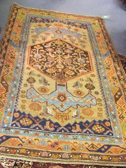 Appraisal: A HAMADAN BROWN GROUND RUG decorated a central medallion within