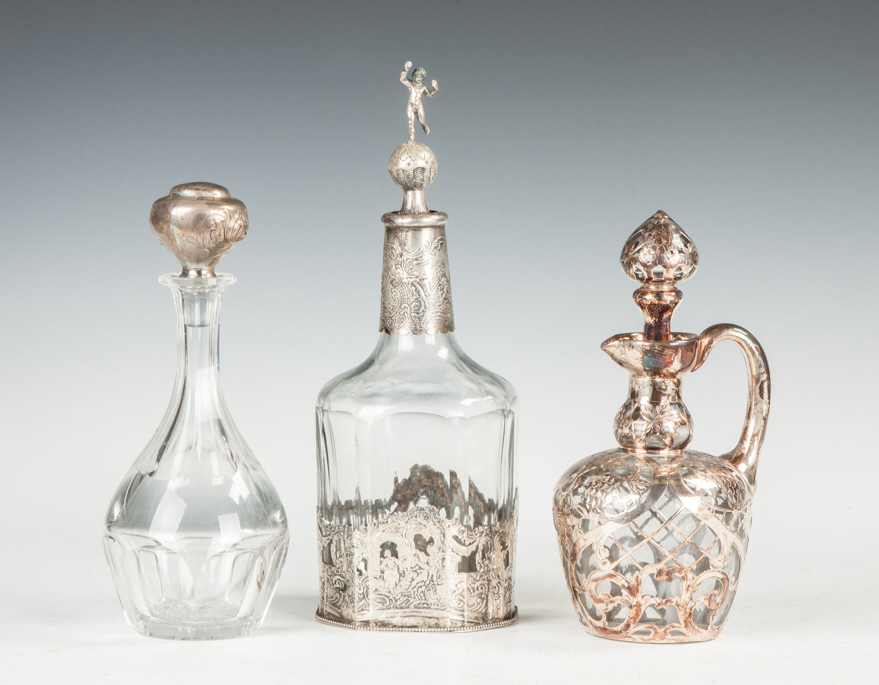 Appraisal: Three Decanters with Silver Stoppers and Overlay