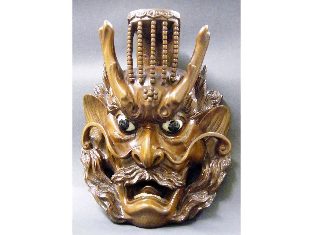 Appraisal: Hardwood carved face mask of a devil with fixed eyes