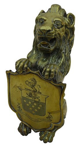 Appraisal: A lion rampant brass door porter holding a shield engraved