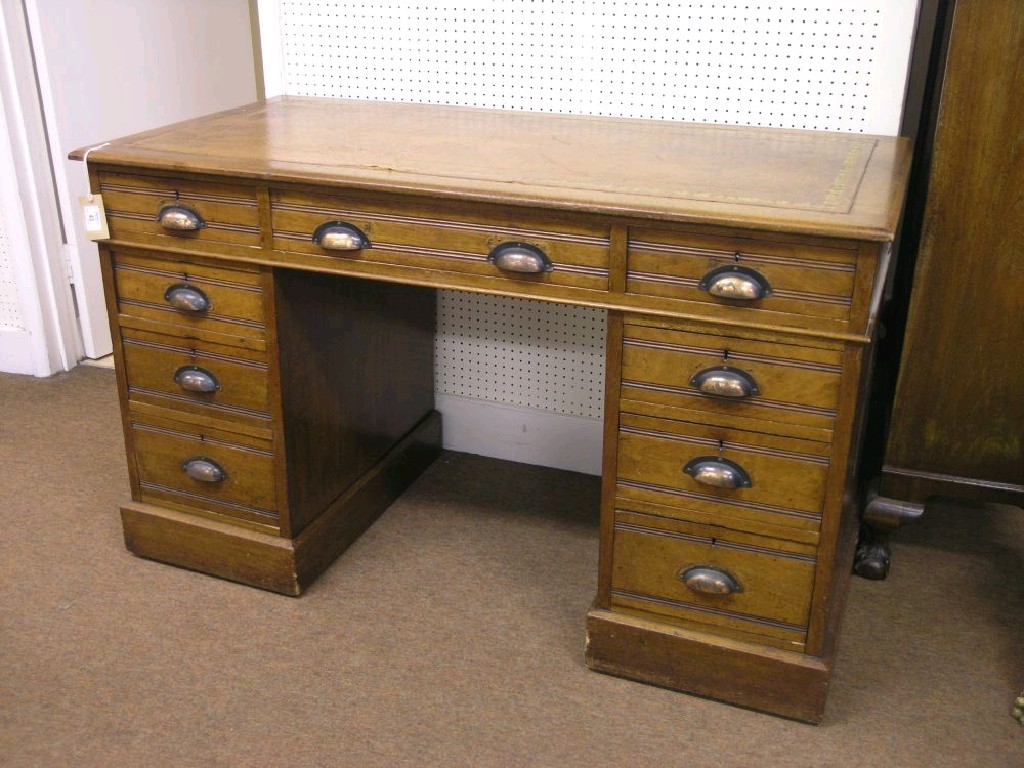 Appraisal: An Edwardian solid walnut pedestal desk inset gilt-tooled leather top