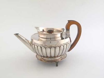 Appraisal: A George III part fluted teapot with a 'cape' rim