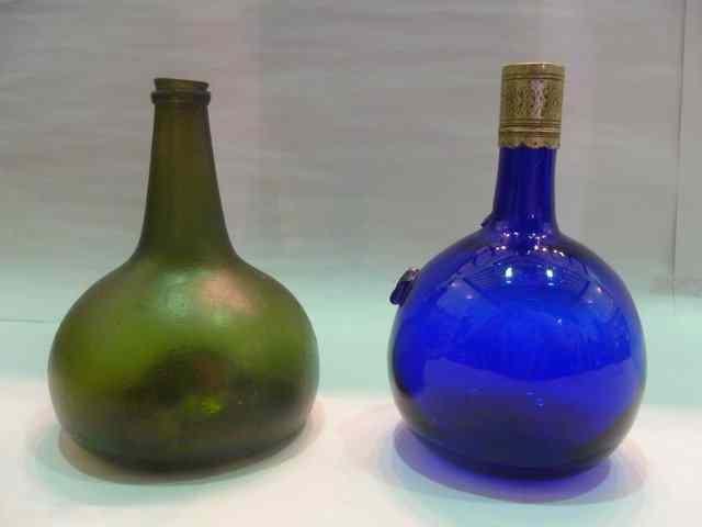 Appraisal: AN EARLY GREEN GLASS WINE BOTTLE and a blue glass