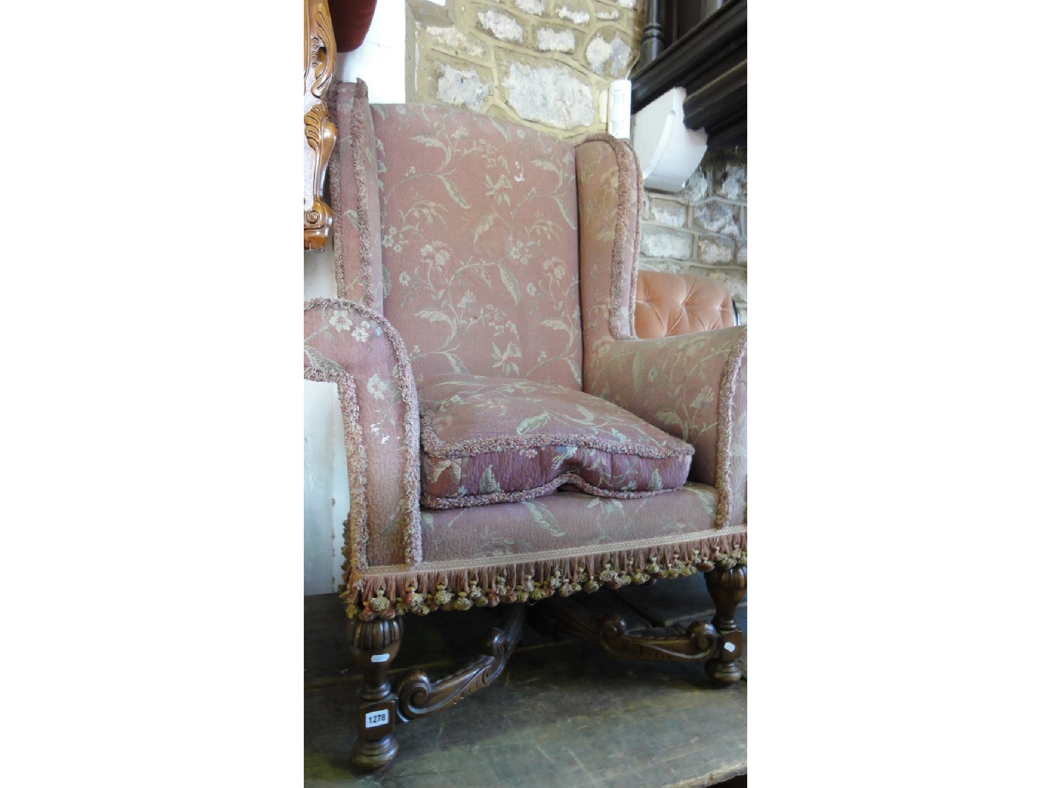 Appraisal: A Victorian wing chair with swept and rolled arms shaped