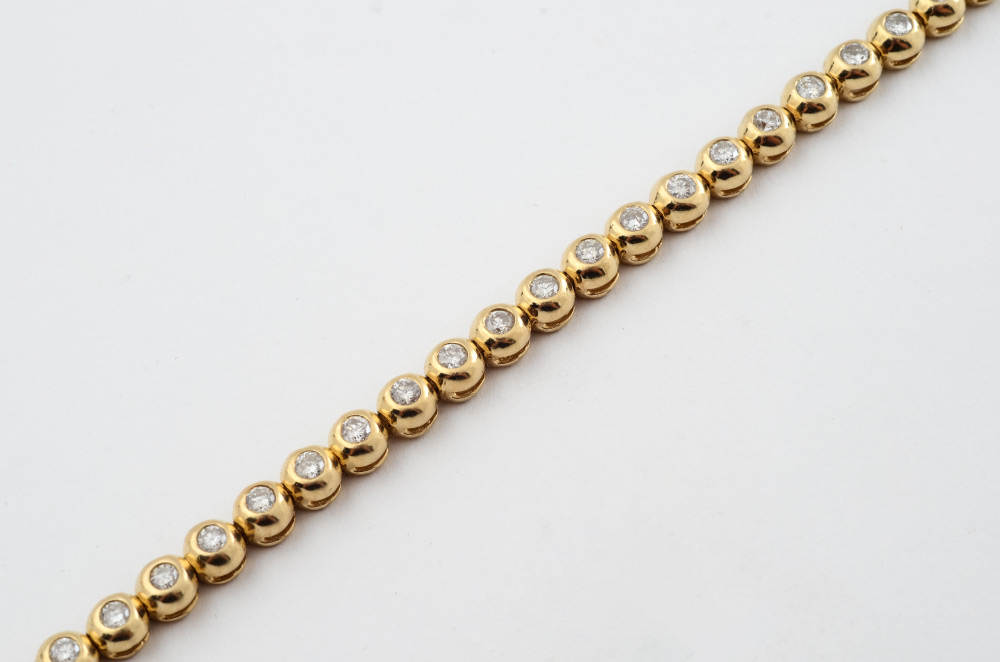 Appraisal: CT DIAMOND TENNIS BRACELET K yellow gold diamond bracelet contains