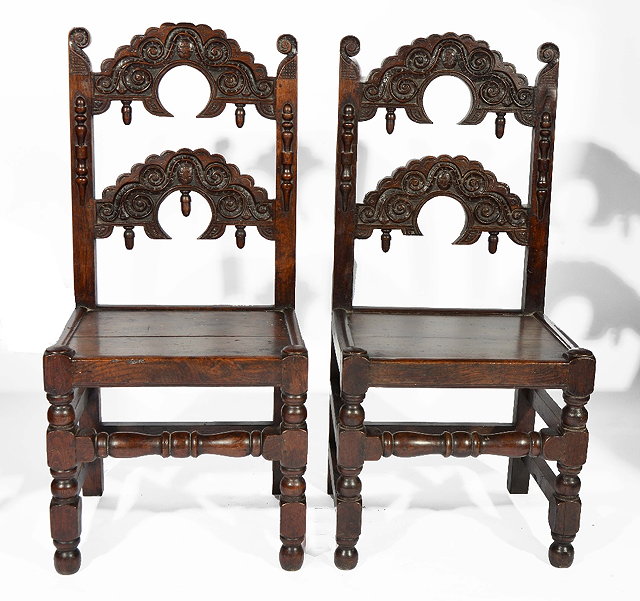 Appraisal: Pair of antique Derbyshire oak hall chairs each with arched