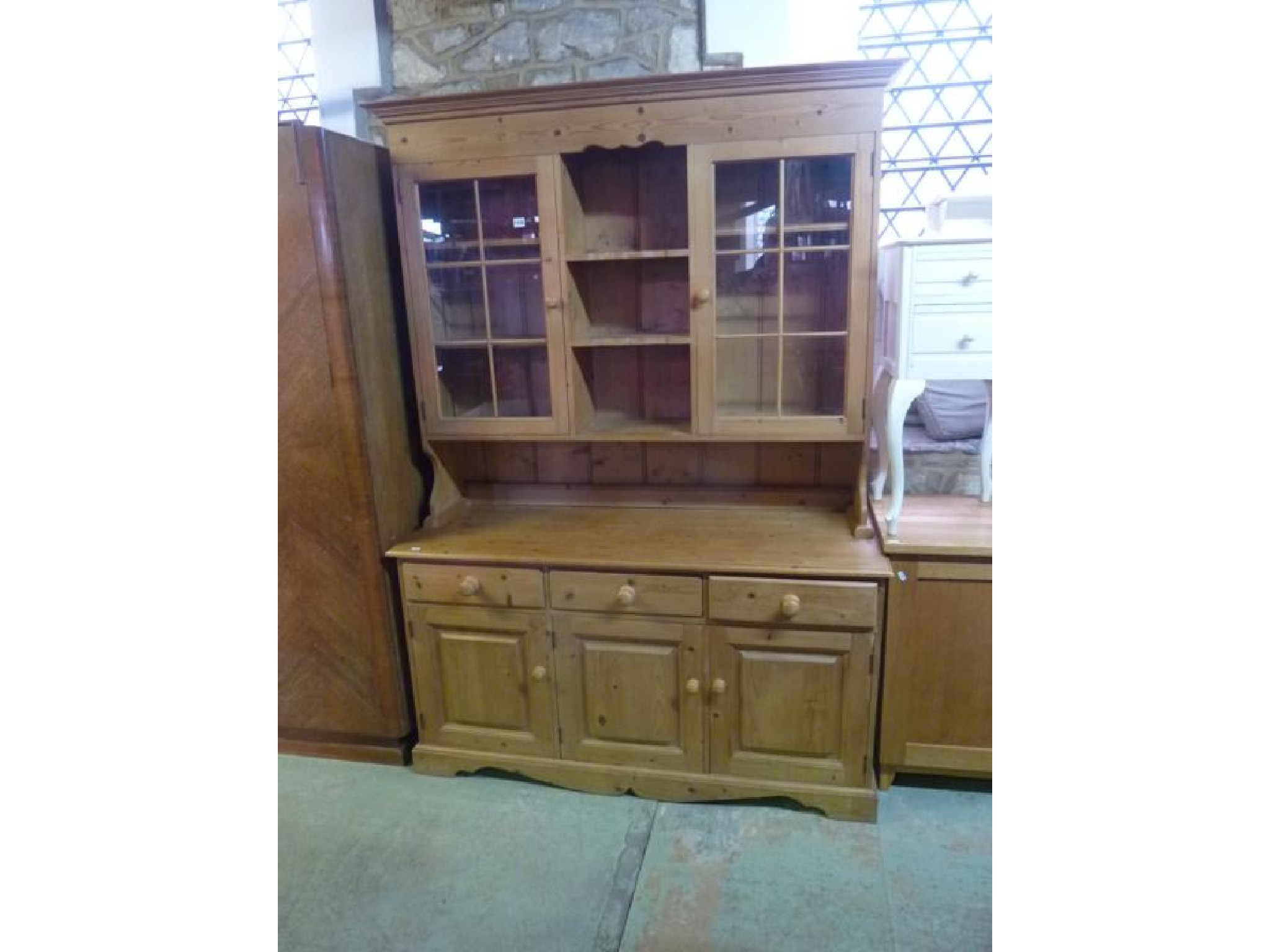 Appraisal: A modern stripped pine kitchen dresser the base enclosed by