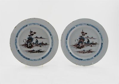 Appraisal: A pair of Delftware plates painted in manganese and blue