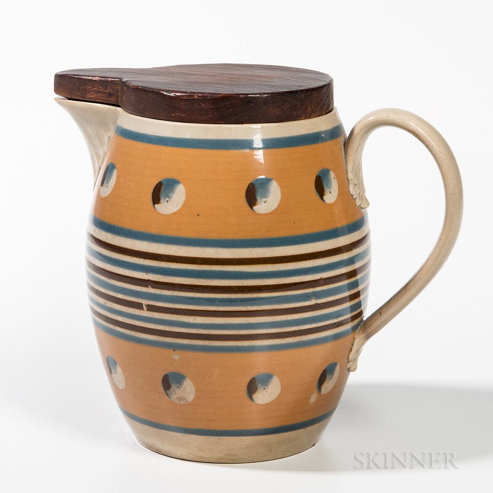 Appraisal: Mocha Cat's-eye Barrel-form Jug with Carved Wood Cover Mocha Cat's-eye