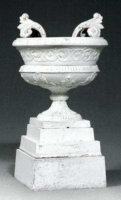 Appraisal: Cast iron garden urn applied handles relief decoration stepped base