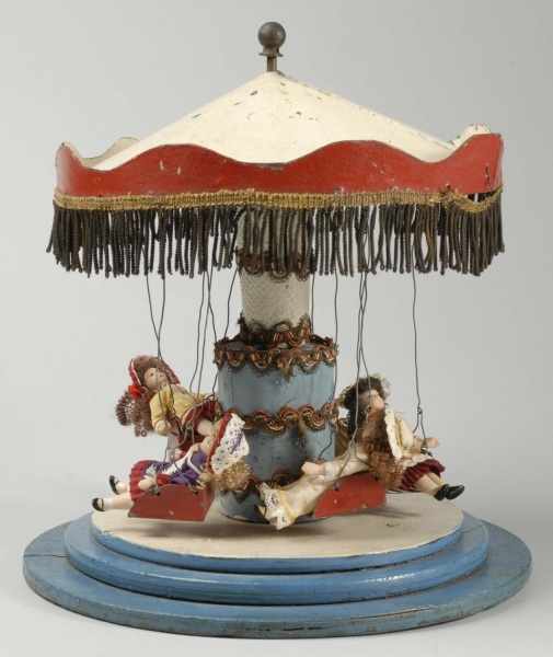 Appraisal: Tin and Wood Swing Carousel Description Wooden round stepped base