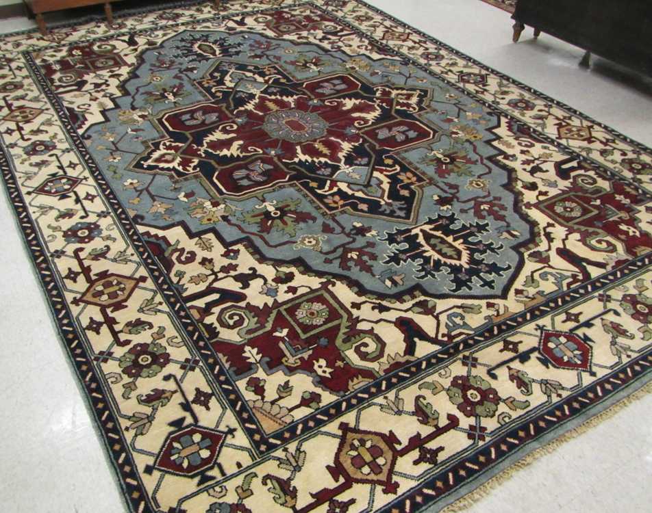 Appraisal: HAND KNOTTED ORIENTAL CARPET Indo-Heriz central geometric medallion and surrounding