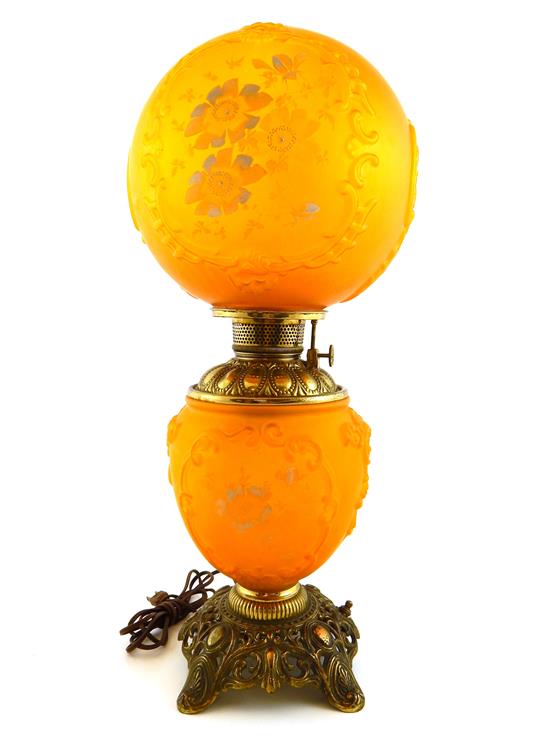 Appraisal: Brass oil lamp with orange glass globe shade and lamp