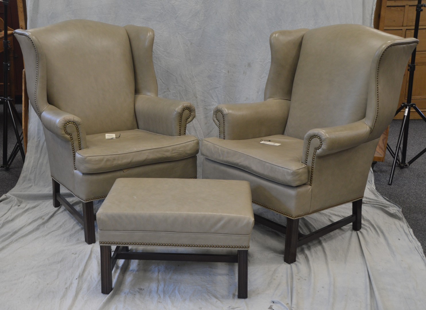 Appraisal: Pair of pale green leather upholstered Chippendale style wing chairs