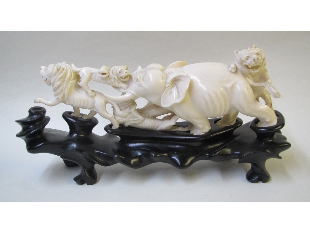 Appraisal: A Chinese ivory tusk carved group of an elephant attacked