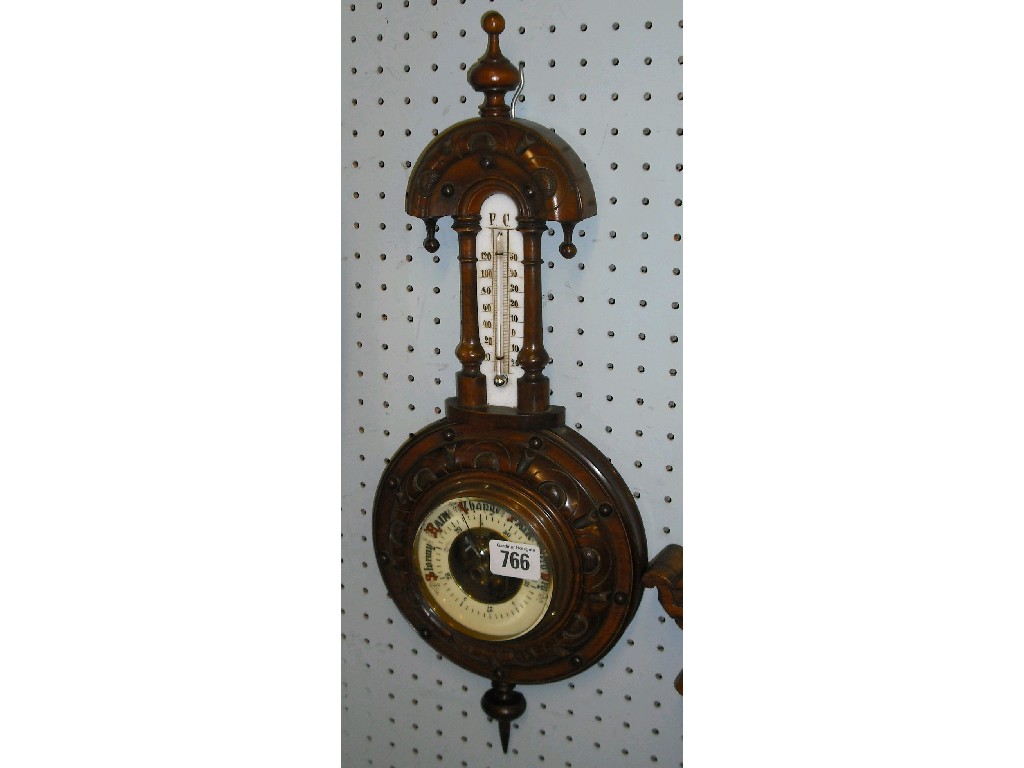 Appraisal: Walnut barometer thermometer the cream dial within a turned carved