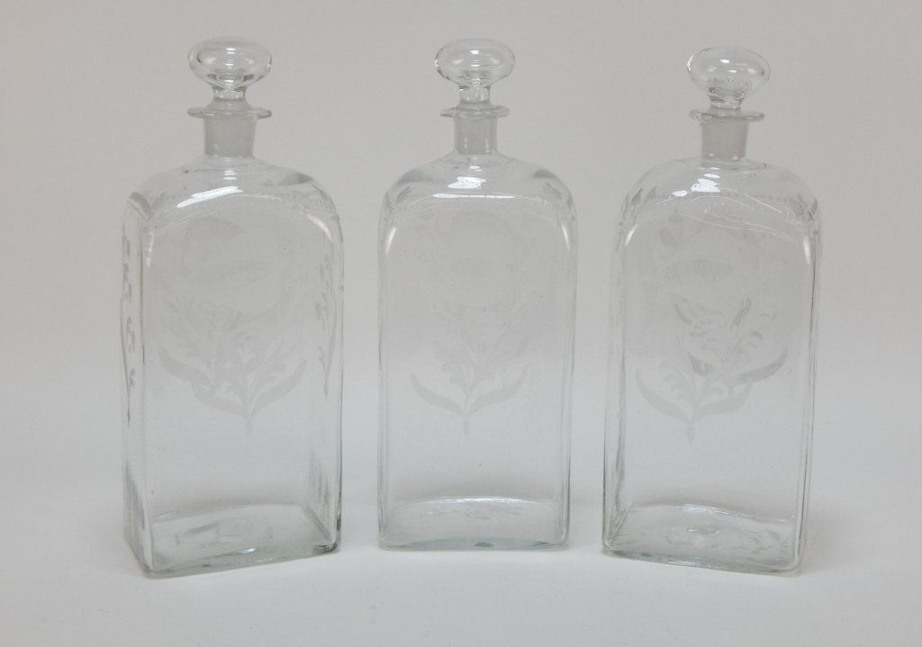 Appraisal: GLASS BOTANICAL ETCHED DECANTER SET Europe th CenturyMatching decanters with