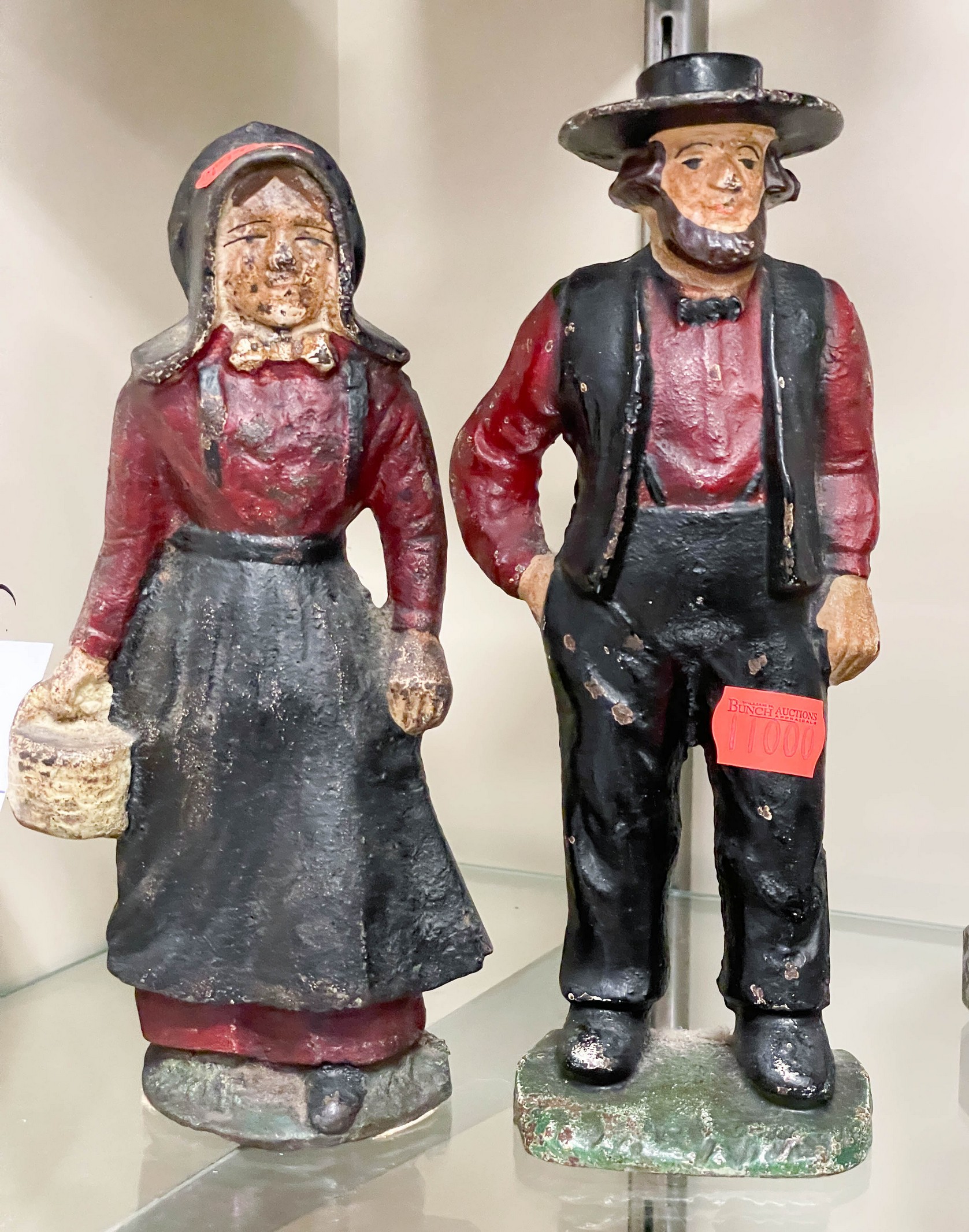 Appraisal: Pair of cast iron door stop bookends Amish man woman