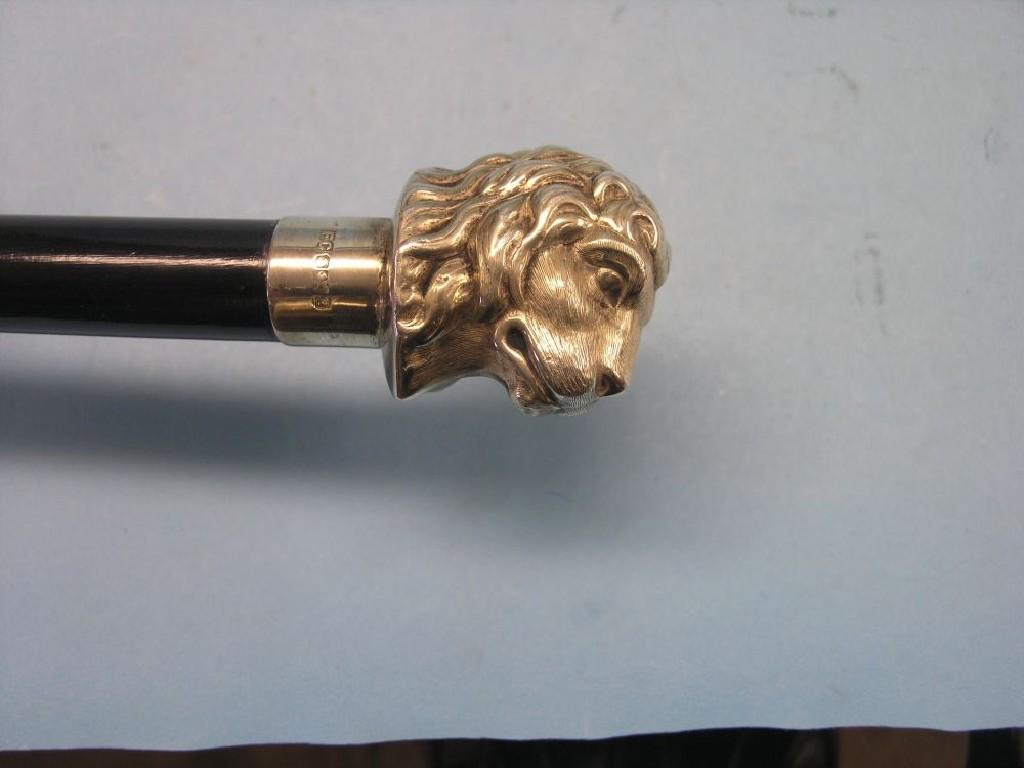 Appraisal: A silver-mounted ebony walking cane silver handle in the form