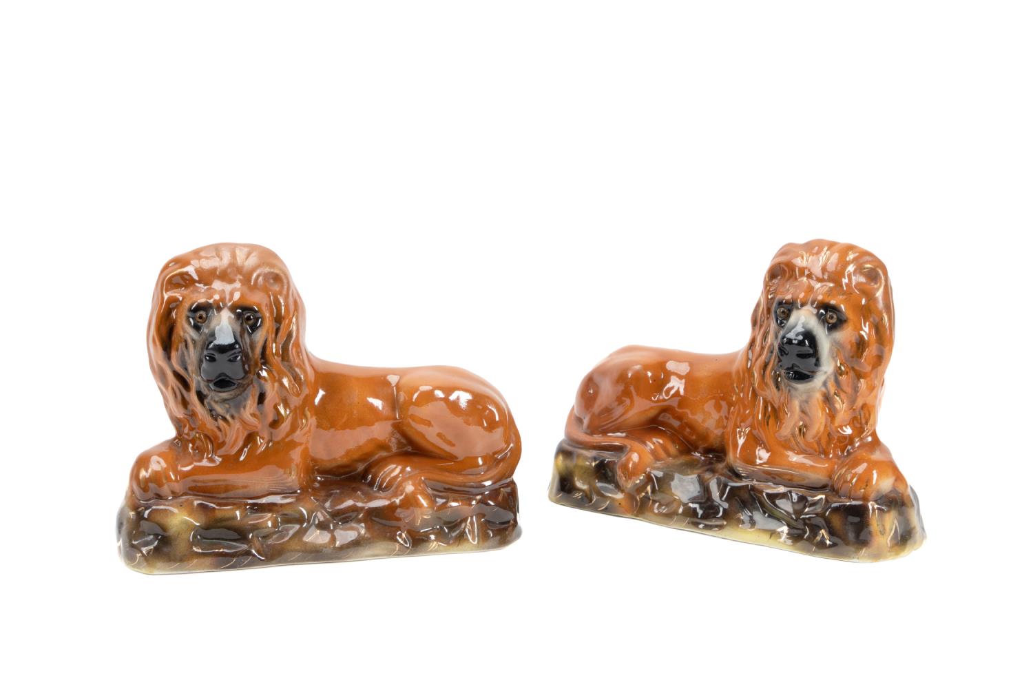 Appraisal: PAIR OF STAFFORDSHIRE LIONS W GLASS EYES Pair of Staffordshire