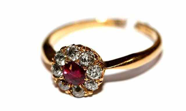 Appraisal: A RUBY AND DIAMOND DRESS RING central ruby surrounded by