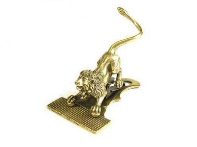 Appraisal: A Victorian brass paper clip cast as a crouching lion