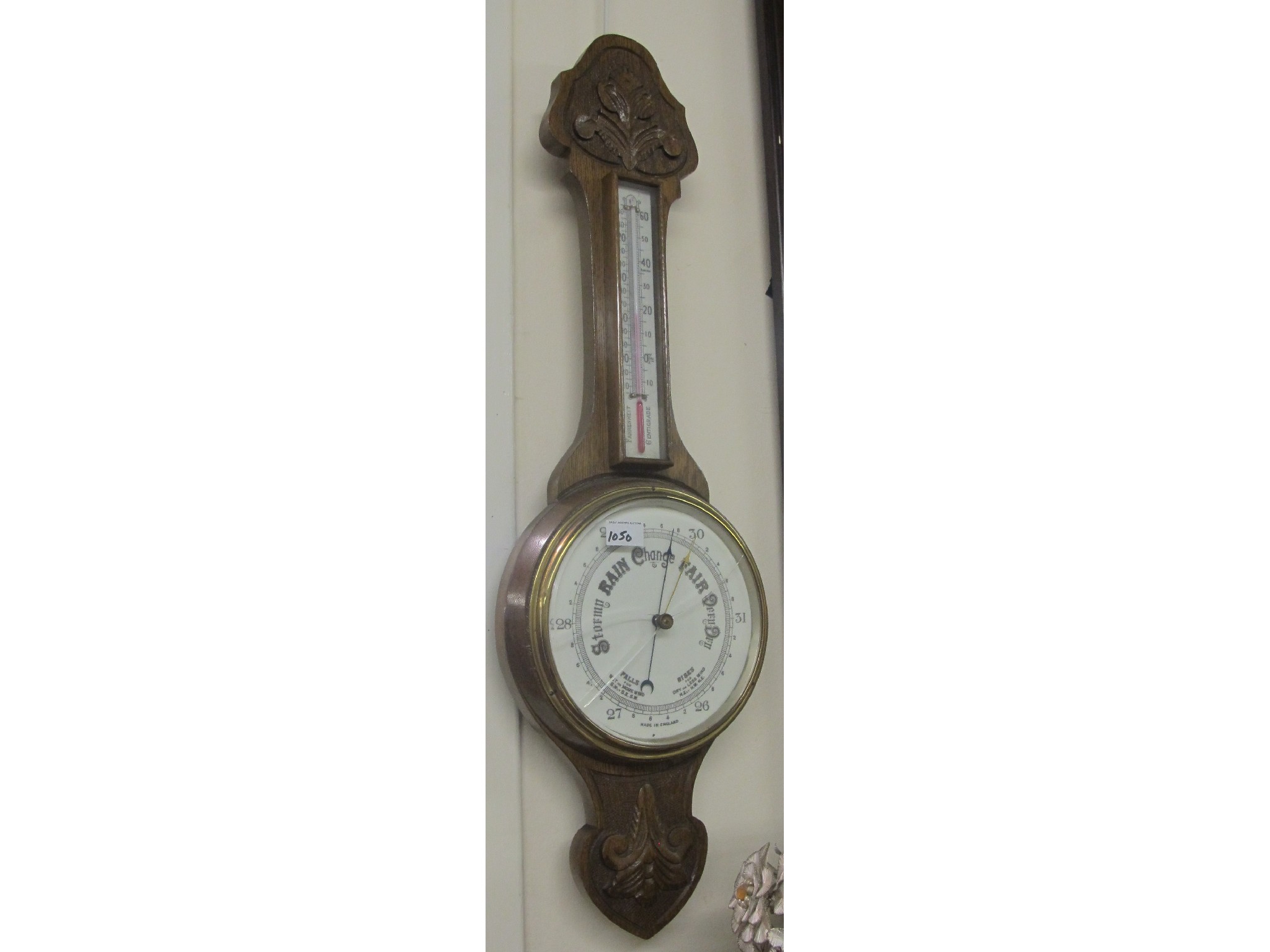 Appraisal: A mahogany wall barometer and thermometer