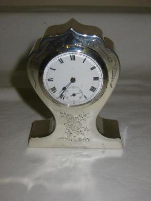 Appraisal: A BOUDOIR CLOCK the white enamel circular face with seconds