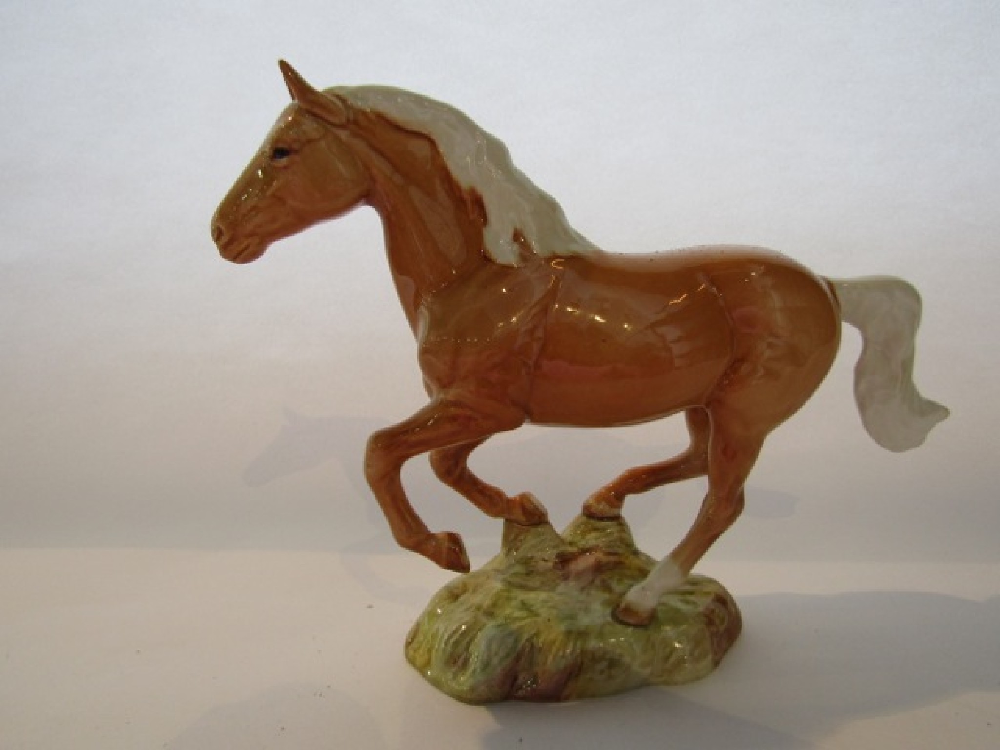 Appraisal: A Beswick model of a galloping palomino pony with impressed